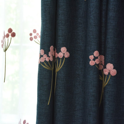 Granatowa zasłona zaciemniająca w haftowane kwiaty.