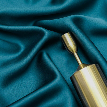 Niebieska welurowa zasłona w haftowane kwiaty.